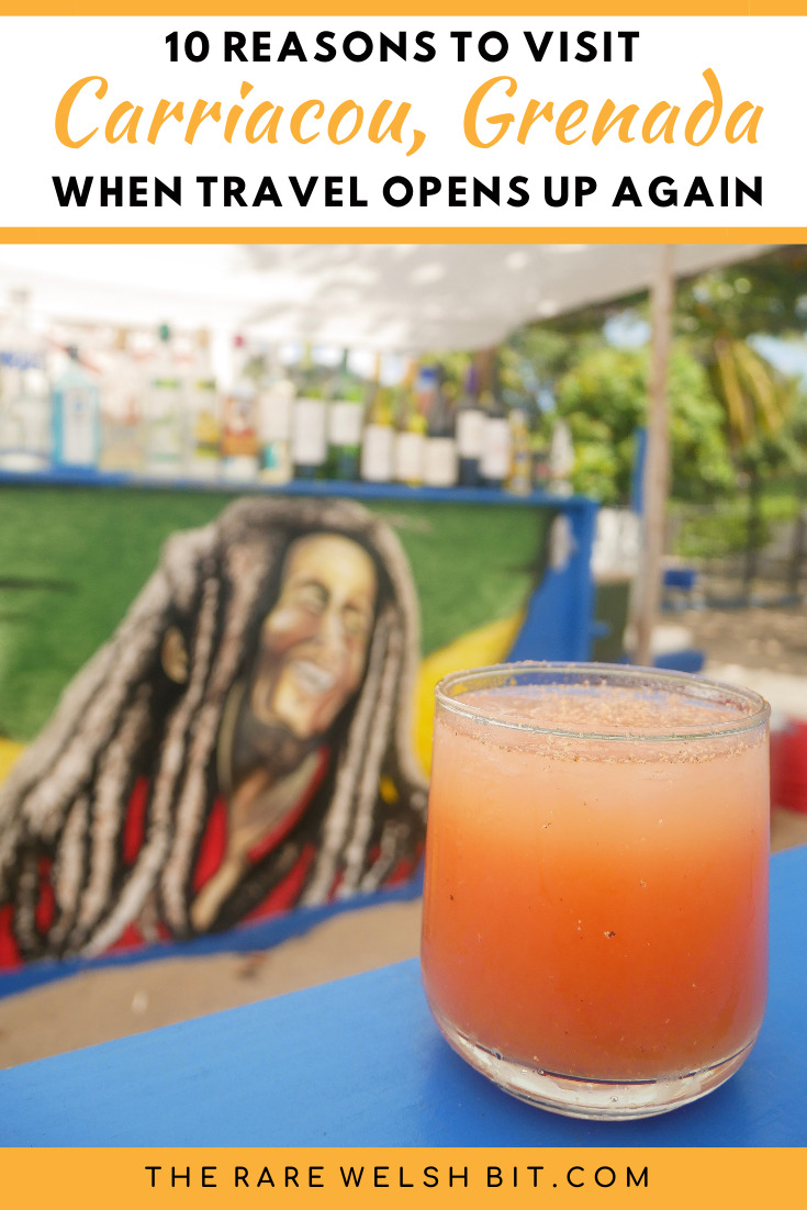 A rum punch with a Bob Marley mural in the background.