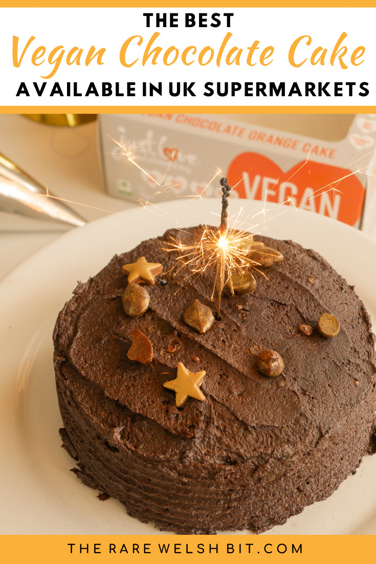 A chocolate cake with a lit sparkler in the middle