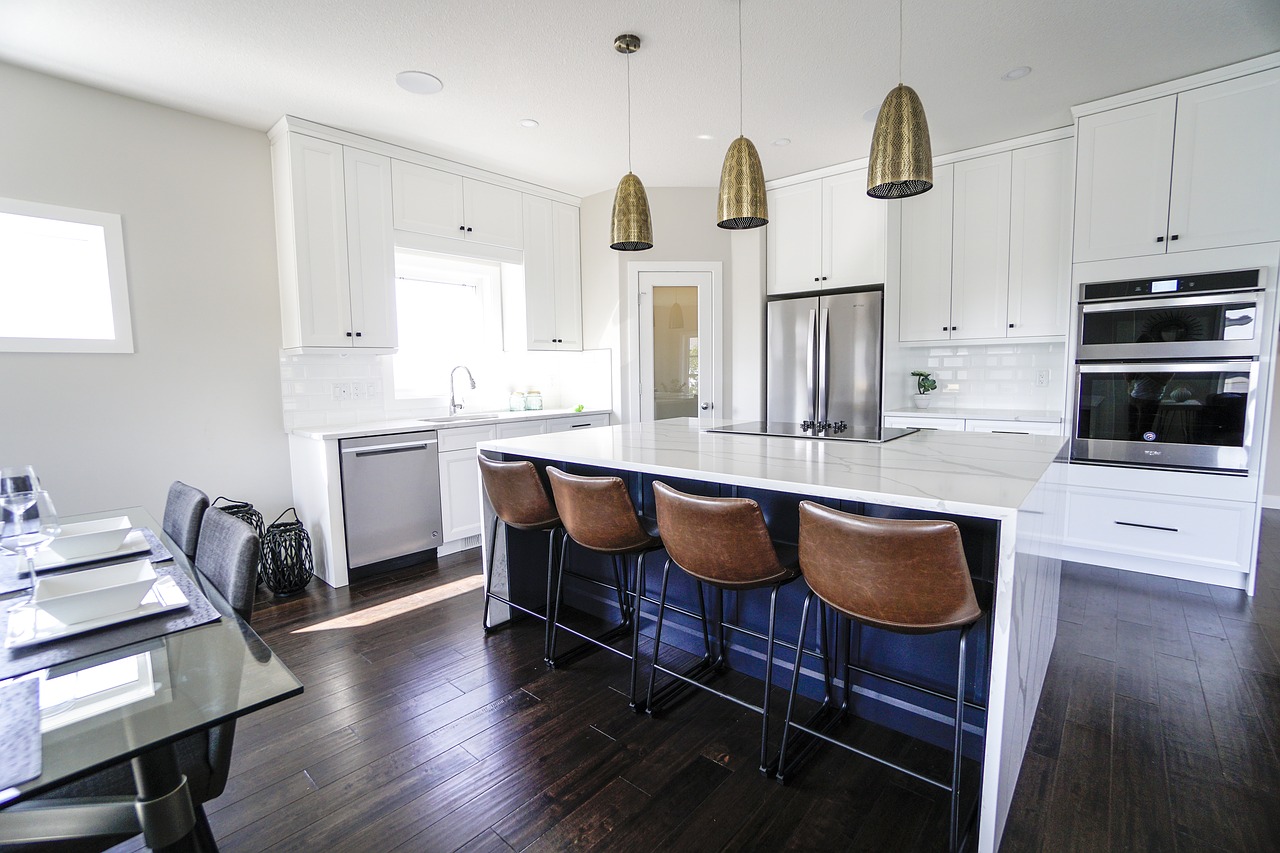 A contemporary kitchen with new wooden flooring.