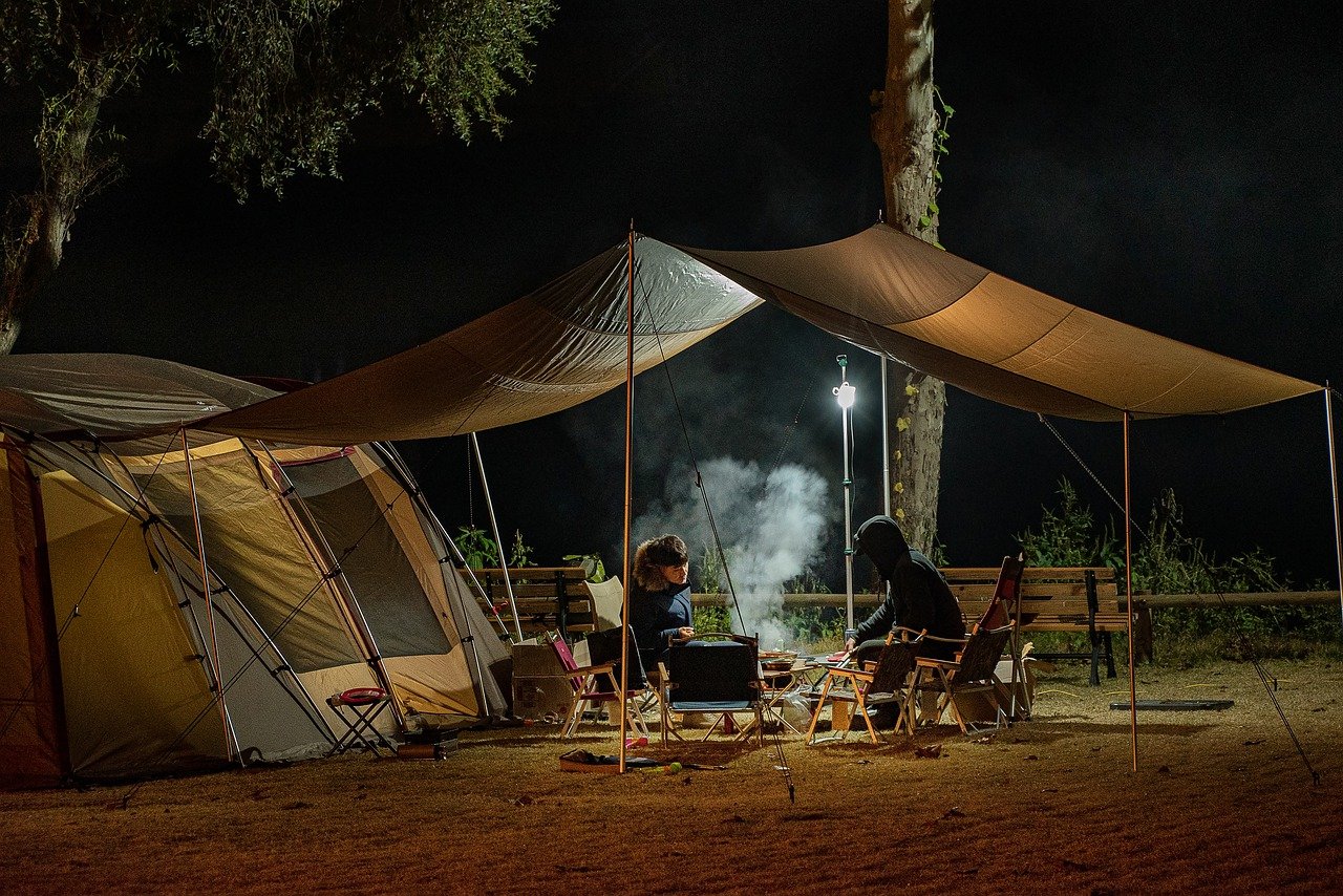 Two friends in a tent on a camping trip