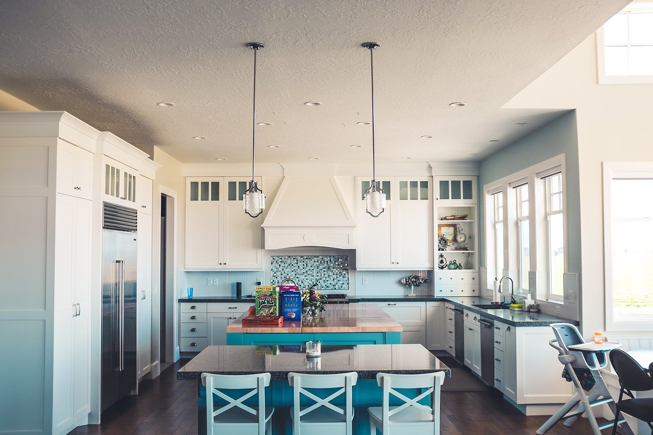 A kitchen with dining room furniture in it.