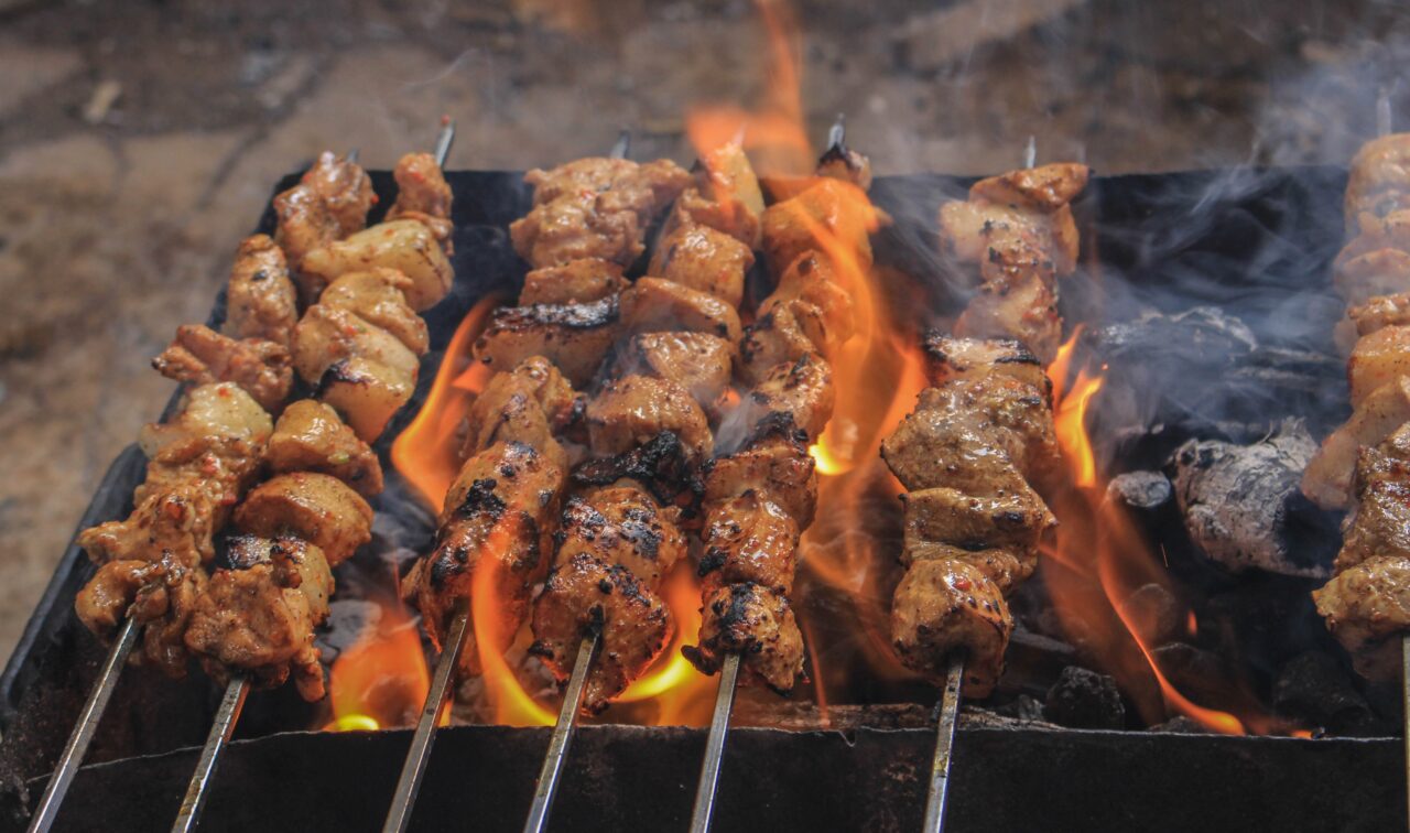 Meat skewers cooking on a barbecue grill