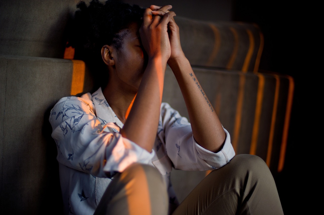 A man with his head in his hands, looking stressed out.