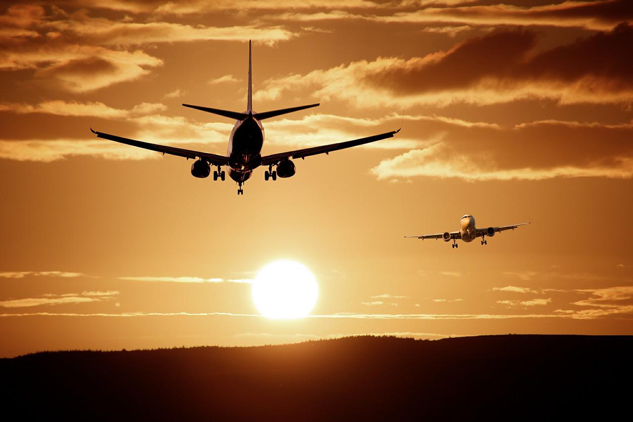 Two planes jetting off into the sunset