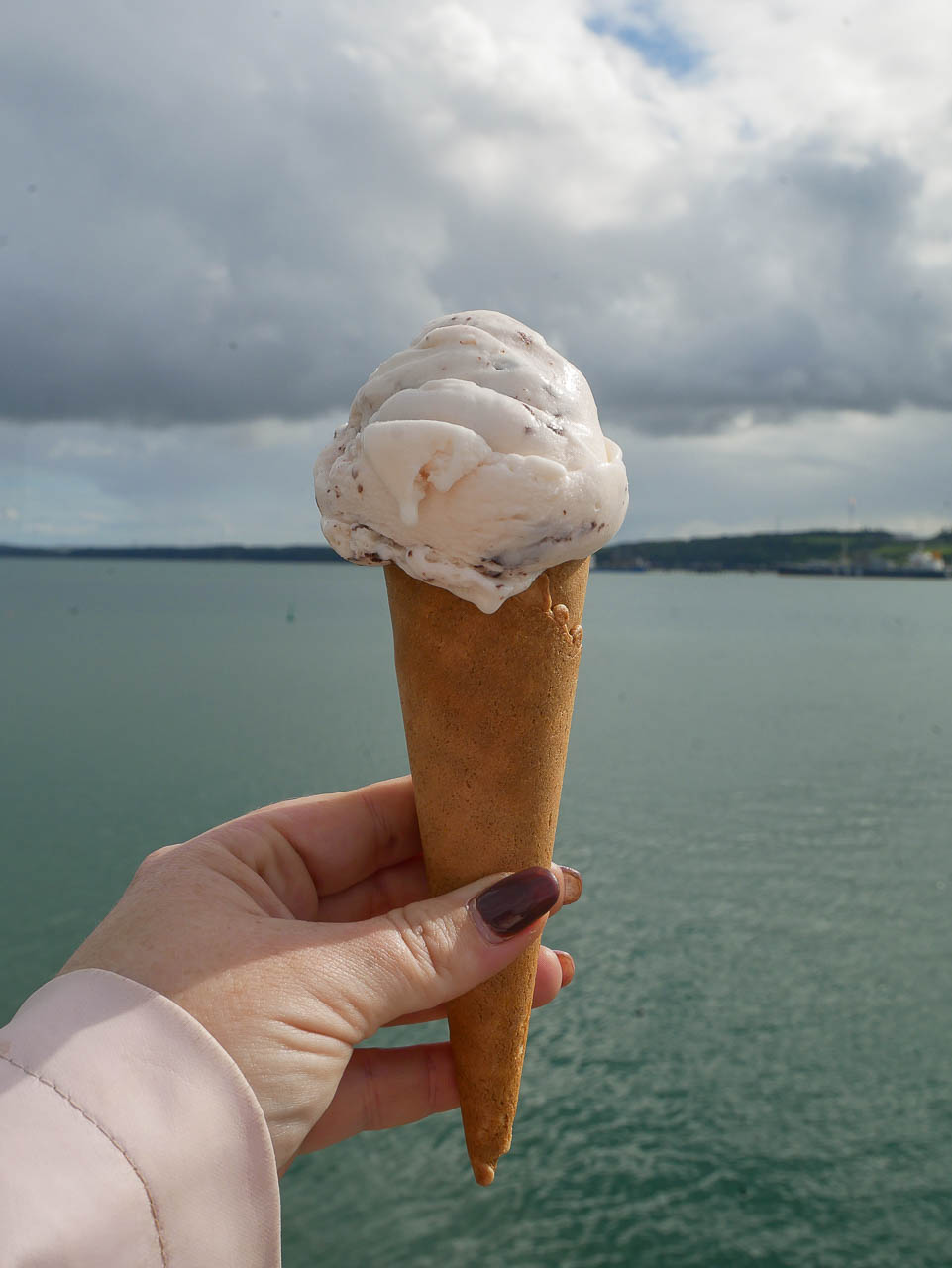 A Turkish Delight ice cream cone from The Scoop, pictured with Milford Waterway in the background