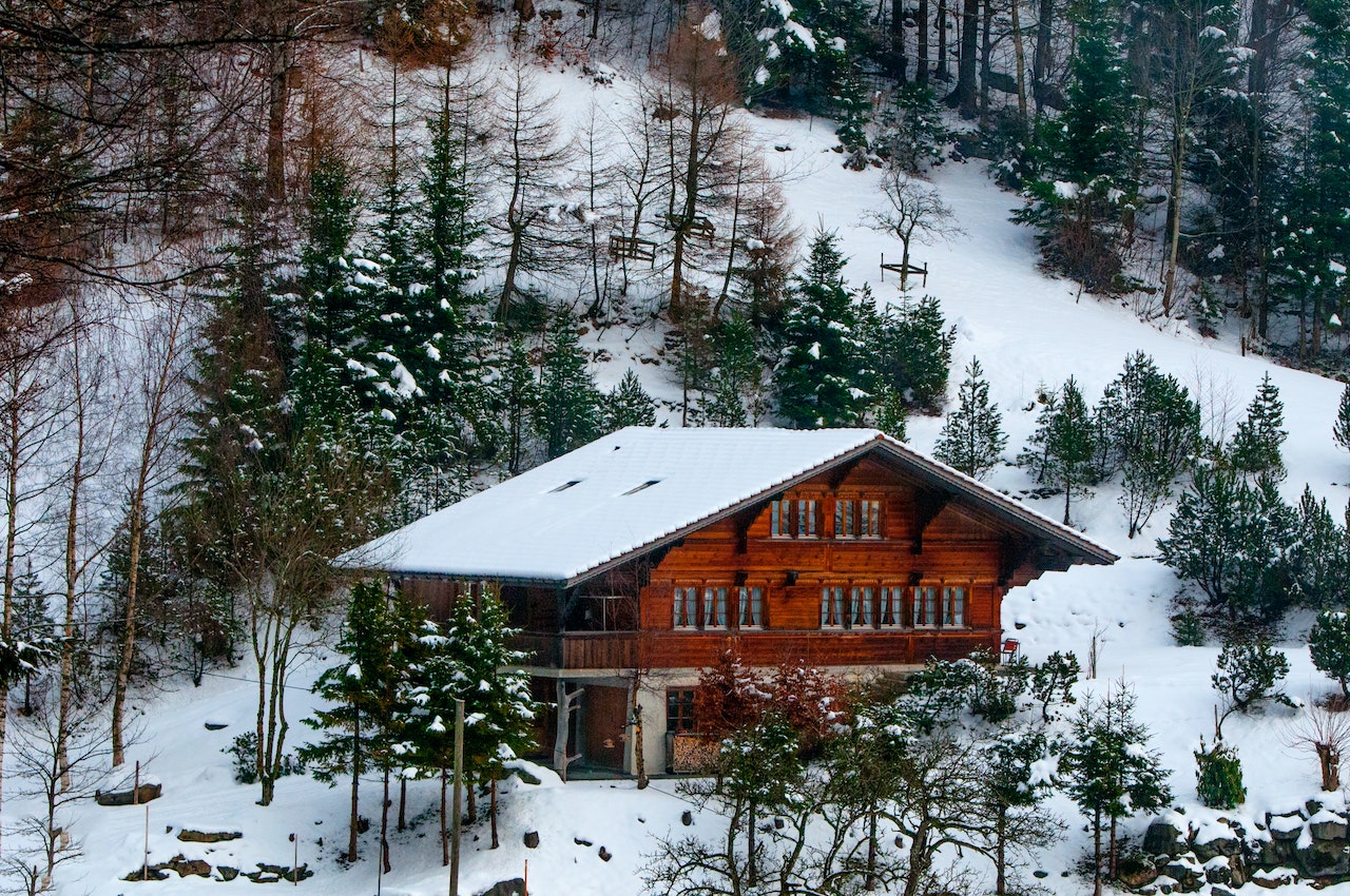Log chalet in the snowy forest in Switzerland