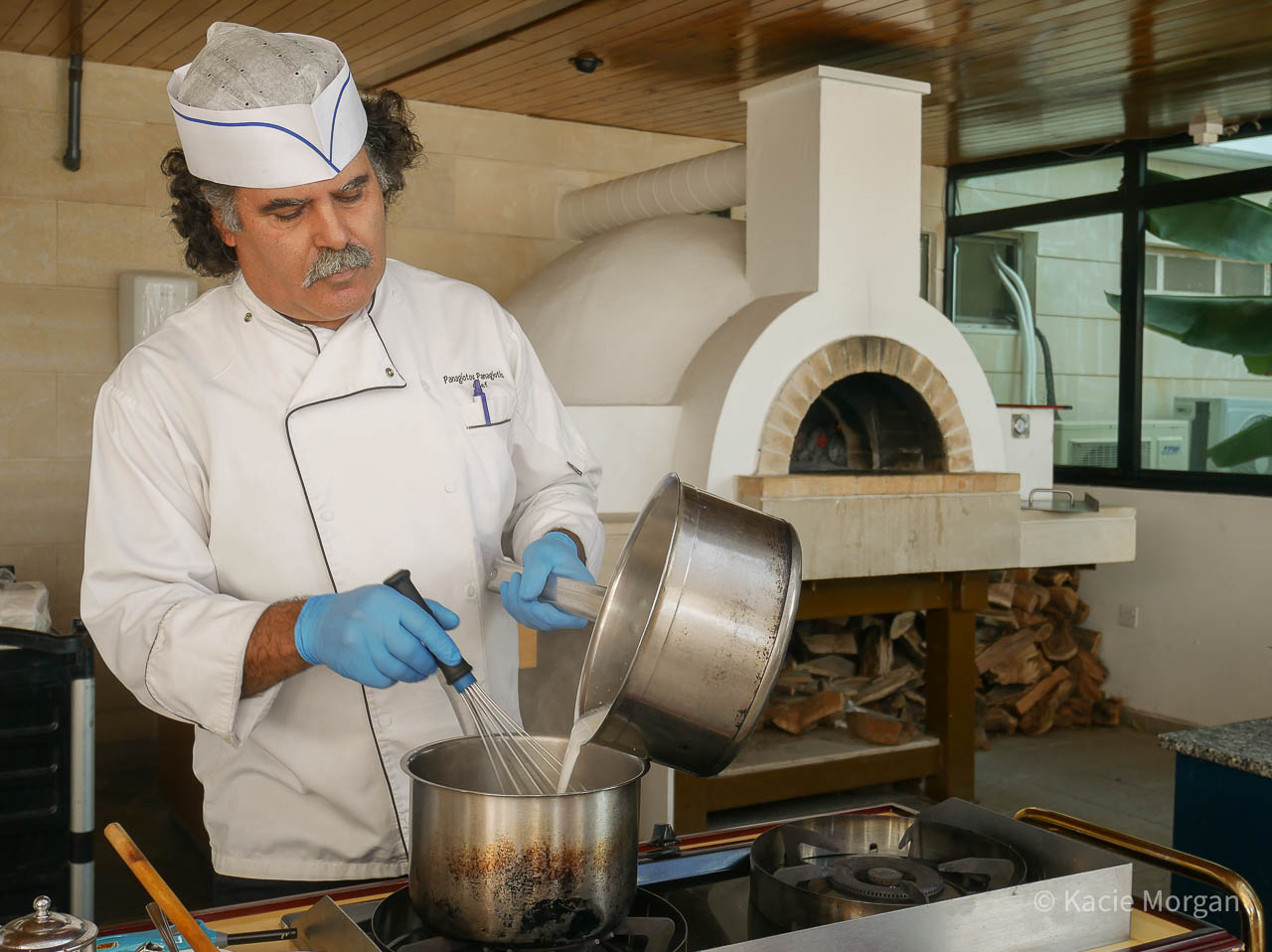 Chef Panagioutou Panagiotis of Constantinou Bros Asimina Suites Hotel, pouring milk into a saucepan as part of his cookery demonstration.