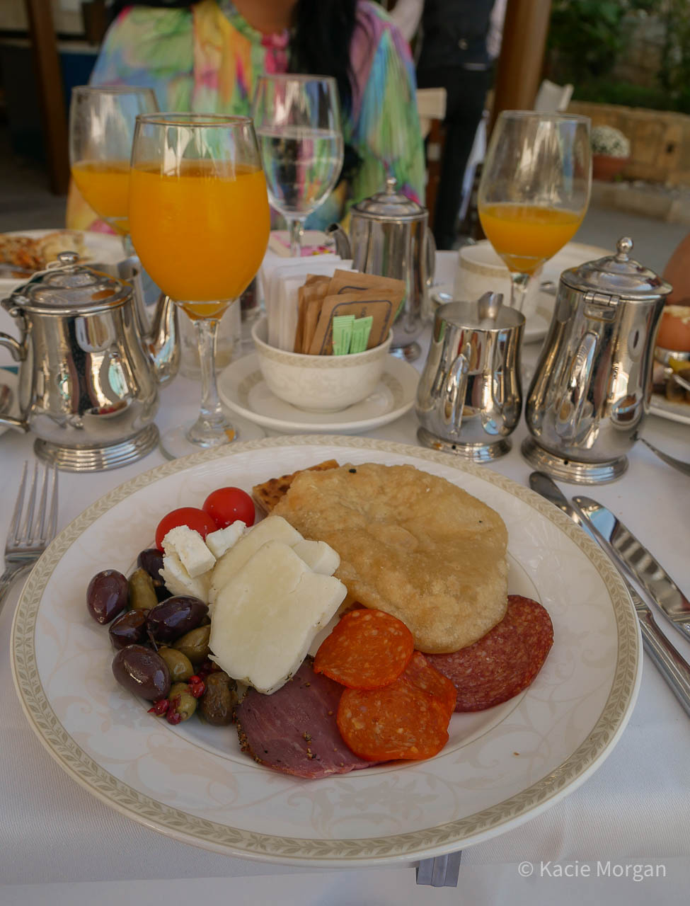 Cypriot style breakfast with cured meats, olives, anari, halloumi, feta chese, tomatoes and traditional Cypriot bakes.