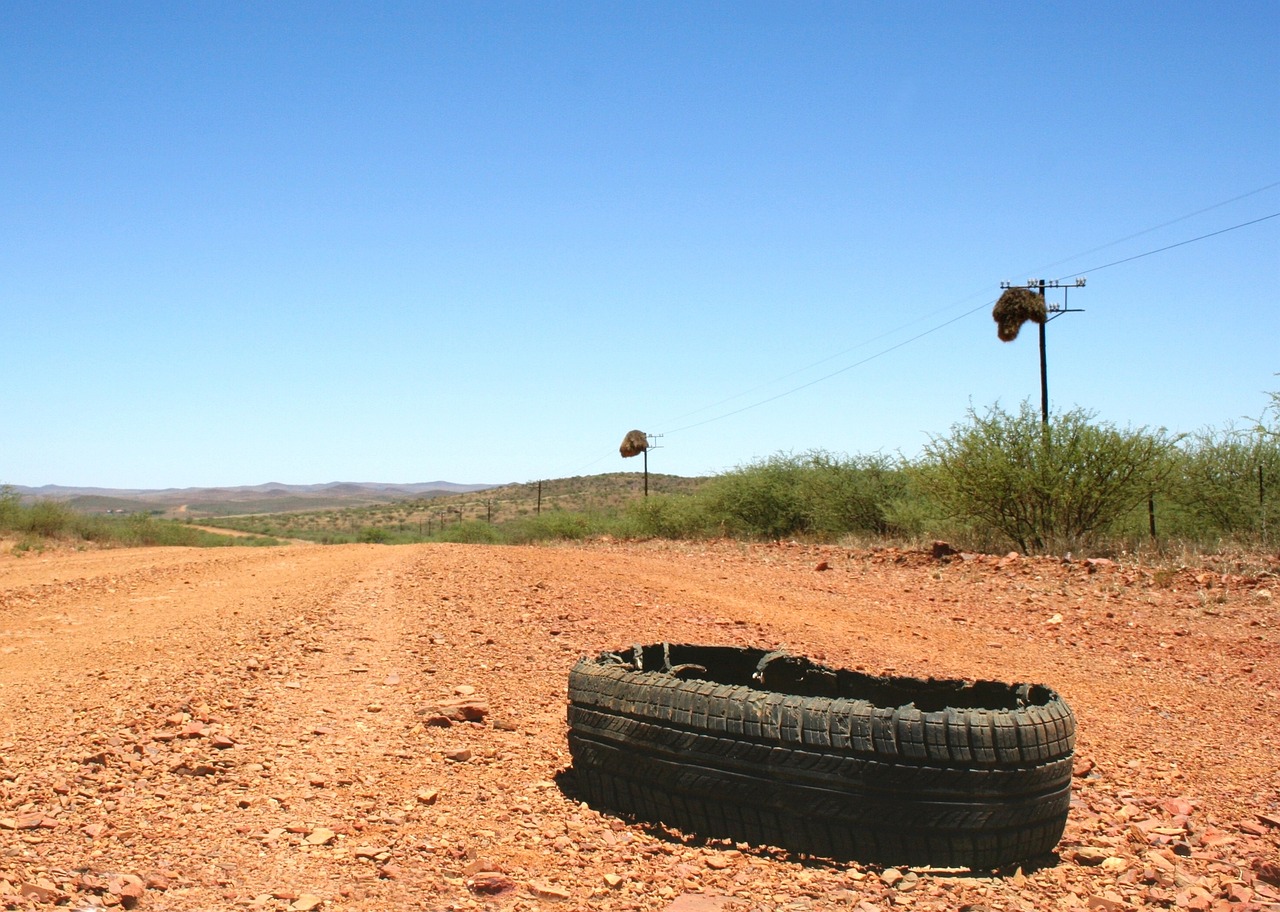 A burst tyre sitting on a dusty old road