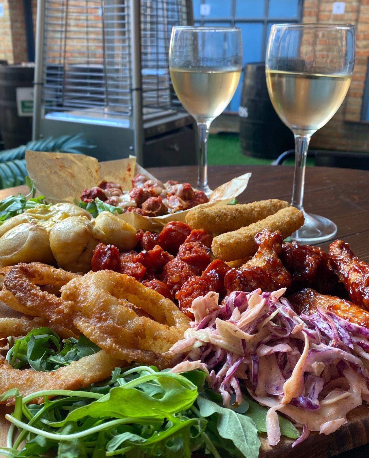Sharing food platter with two glasses of wine