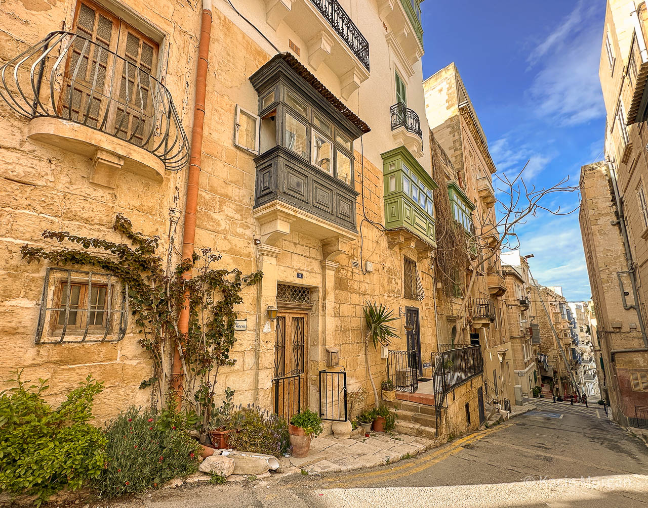 An elaborate limestone residence in Valletta, leading onto an old winding street