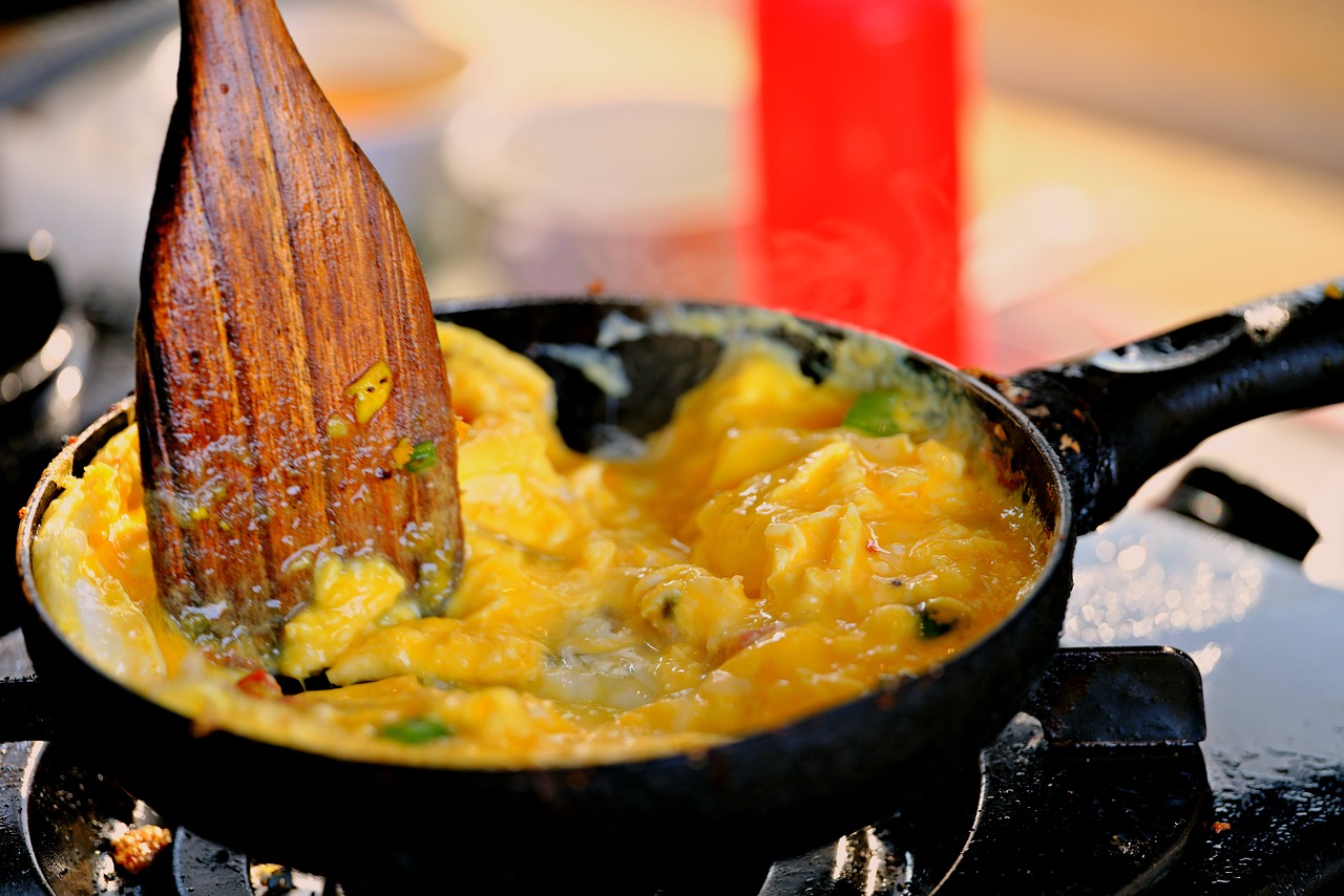 Cooking omelette in a small pan on a stove