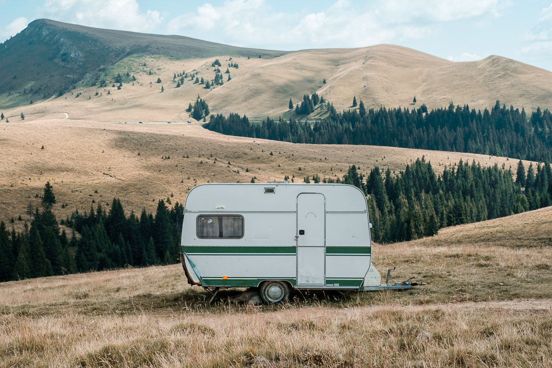 A static caravan sitting in the middle of the countryside, on its own.
