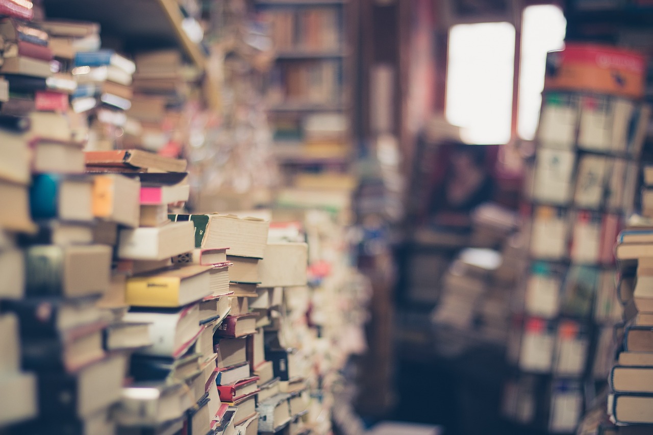Stacks of books piled up in a library