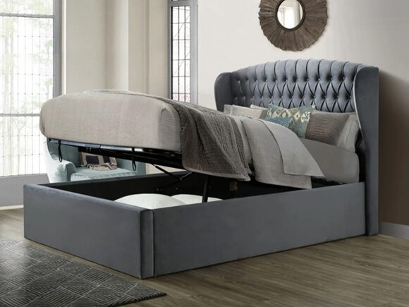 A grey ottoman bed, lifted up so you can see the storage space underneath.