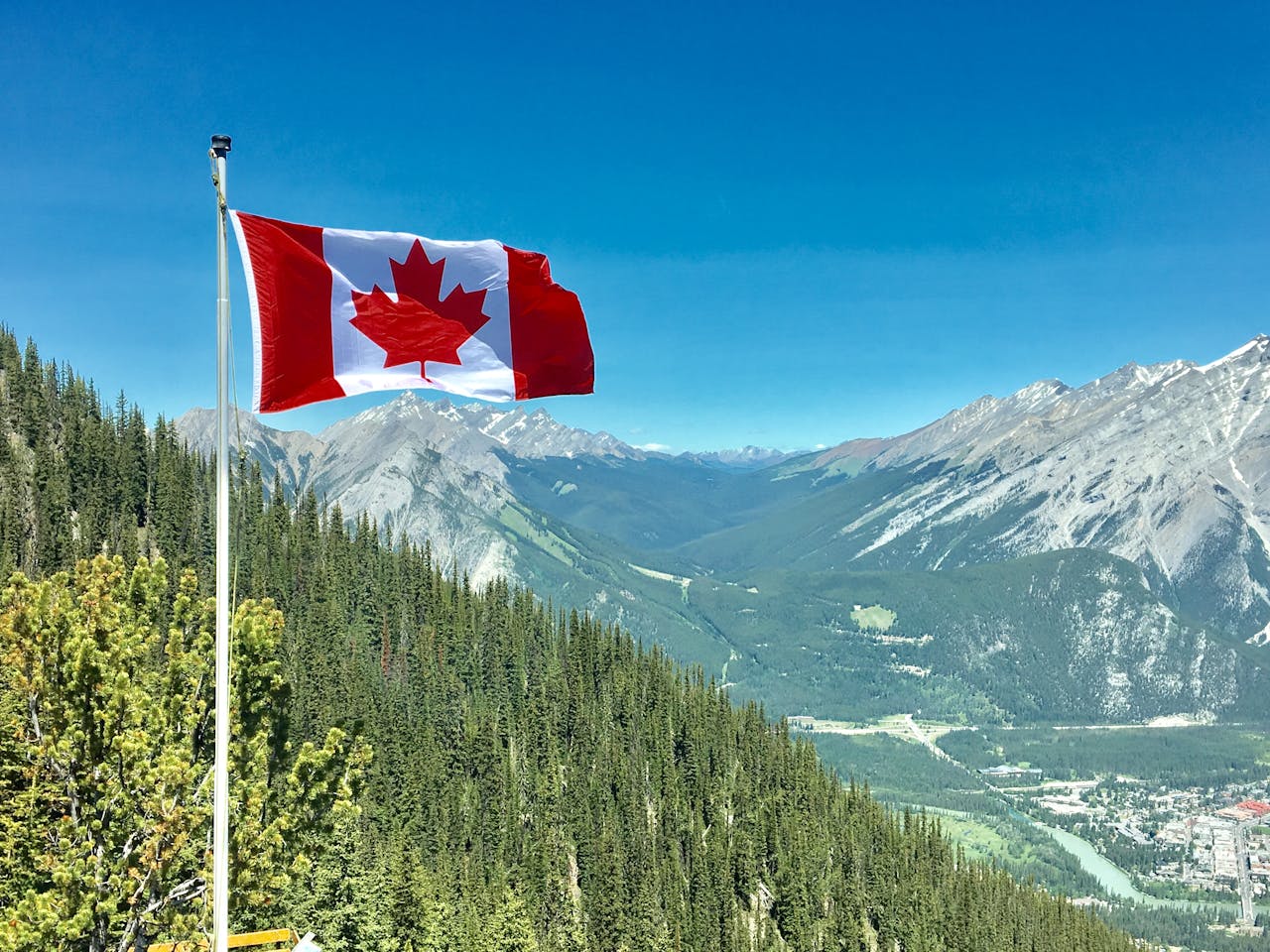 Canadian flag with mountain scene in background