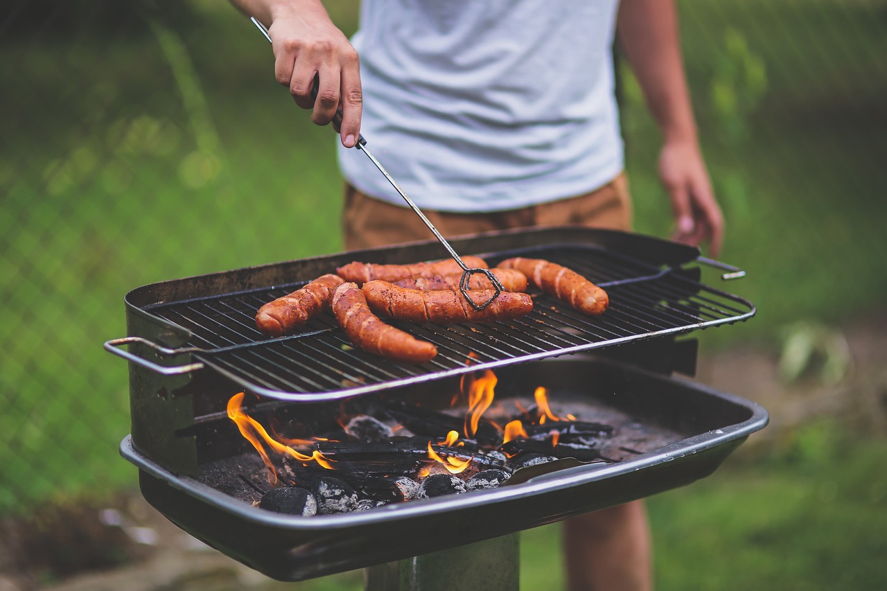 A man grilling meat on a barbecue