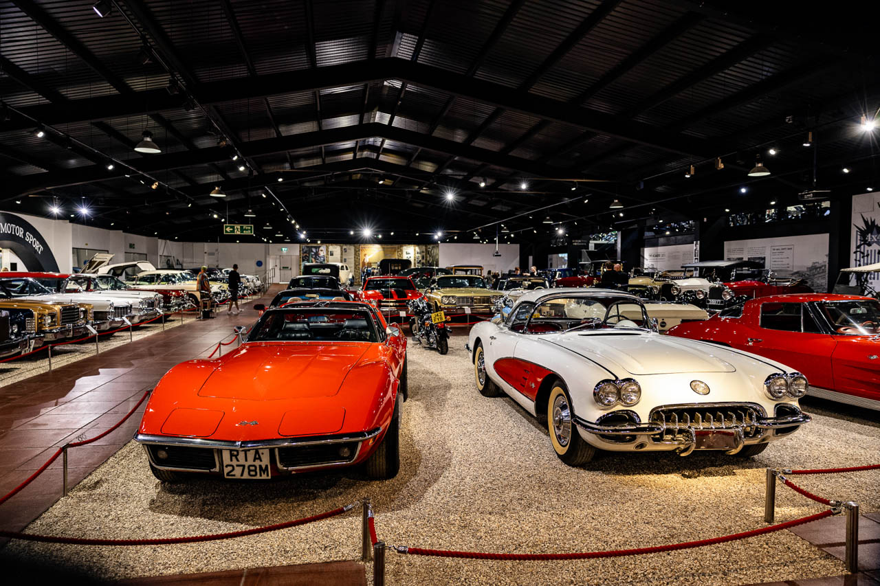 rows of cars arranged side by side in a show room at a motor show