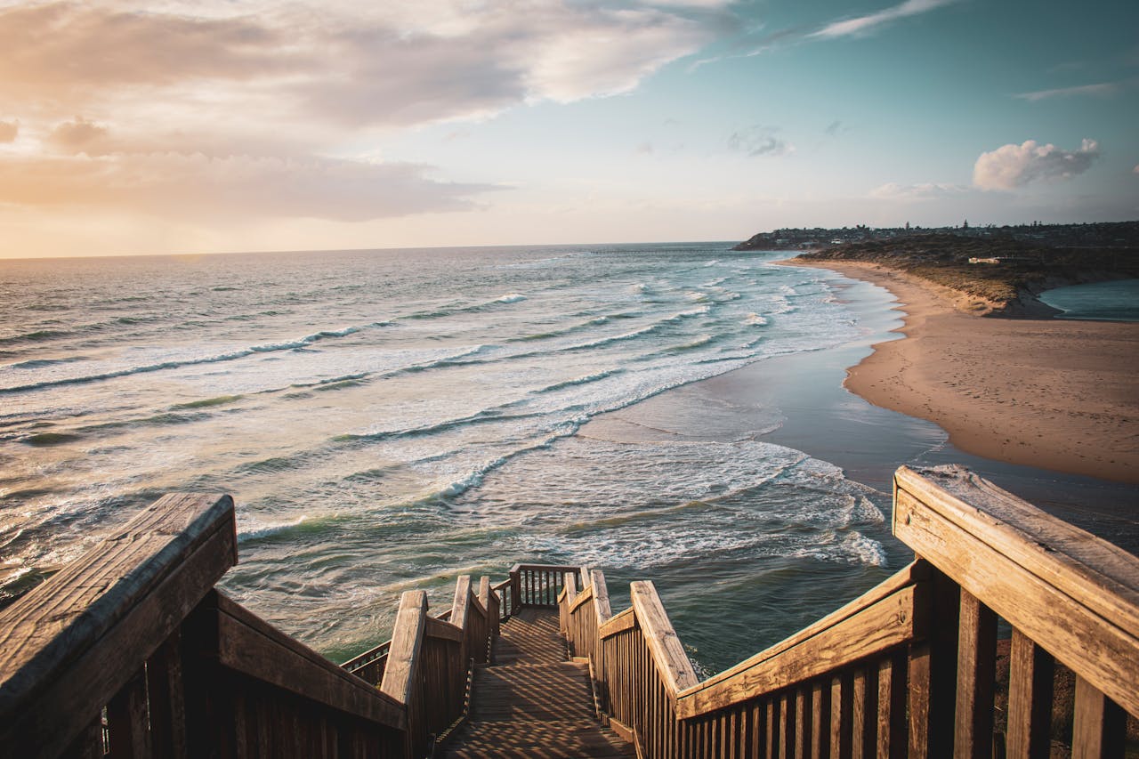 Wooden stairs leading down to a beach in Adelaide, Australia