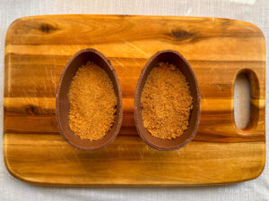 Hollow chocolate Easter eggs filled with a cheesecake base made using crushed digestive biscuits and melted butter