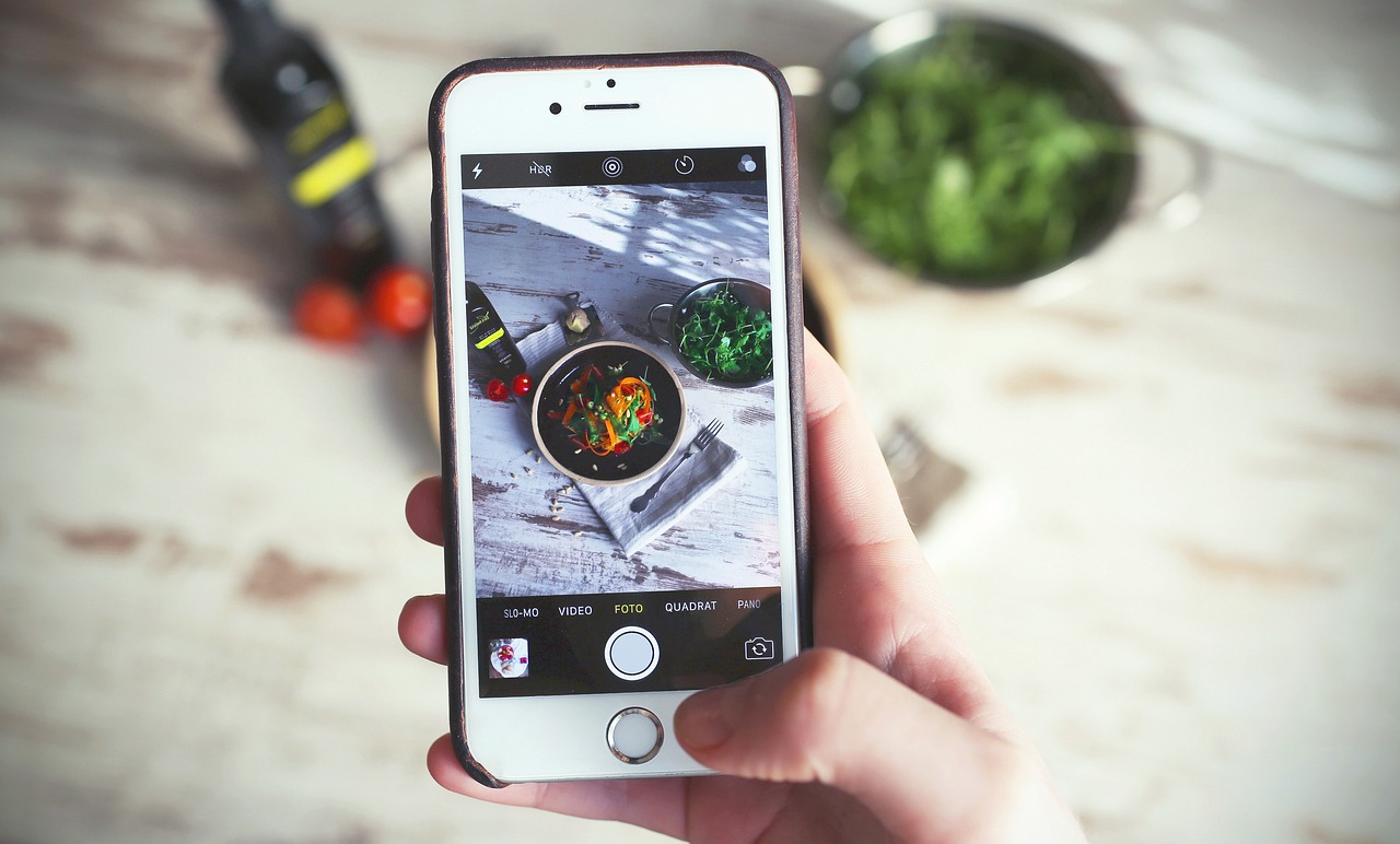 Someone taking a photo of a fresh food arrangement on their iphone