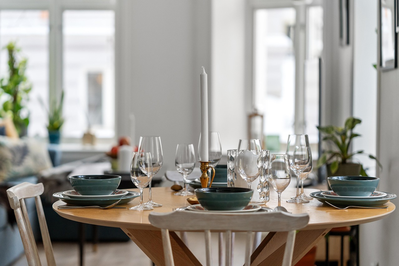 A bright, airy dining room with the table set for dinner