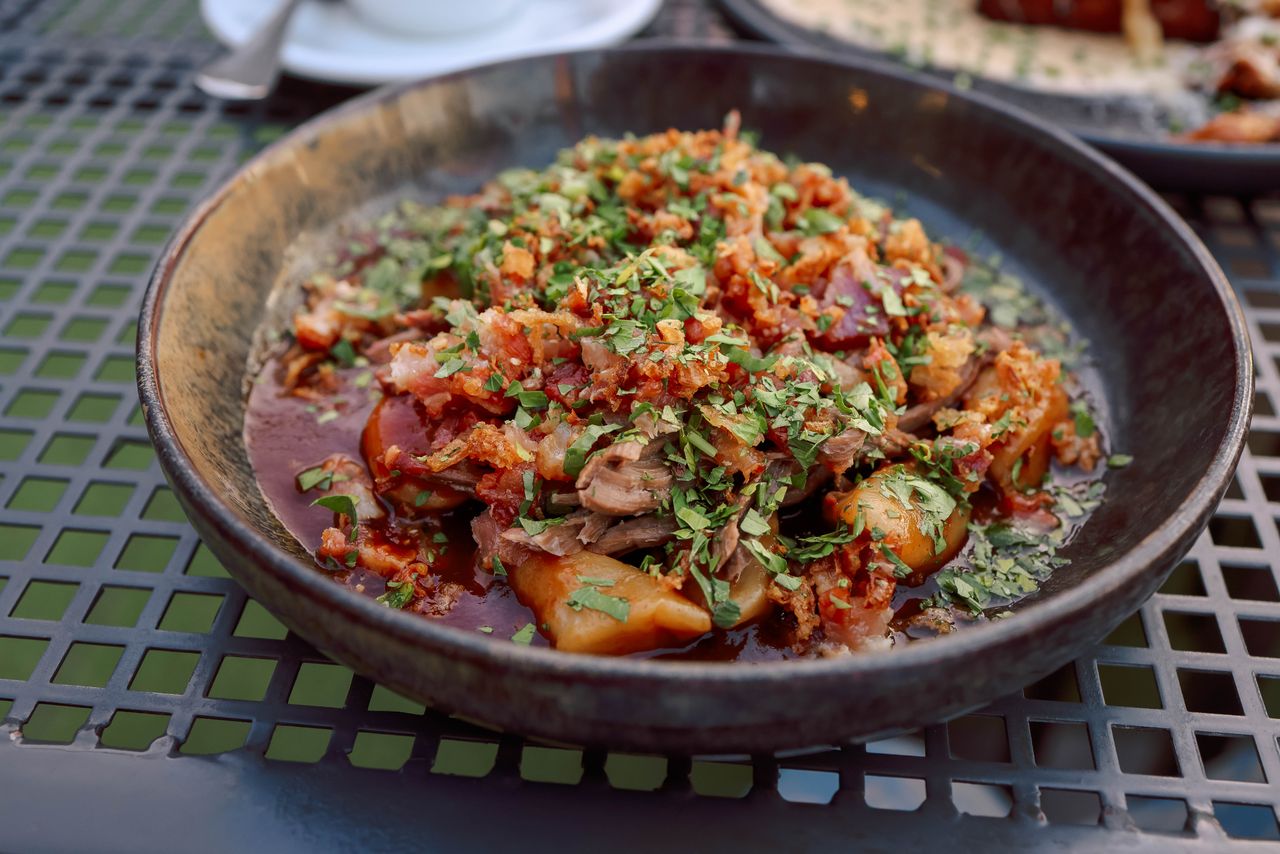 Delicious beef stew with mixed vegetables and herbs, served hot outdoors