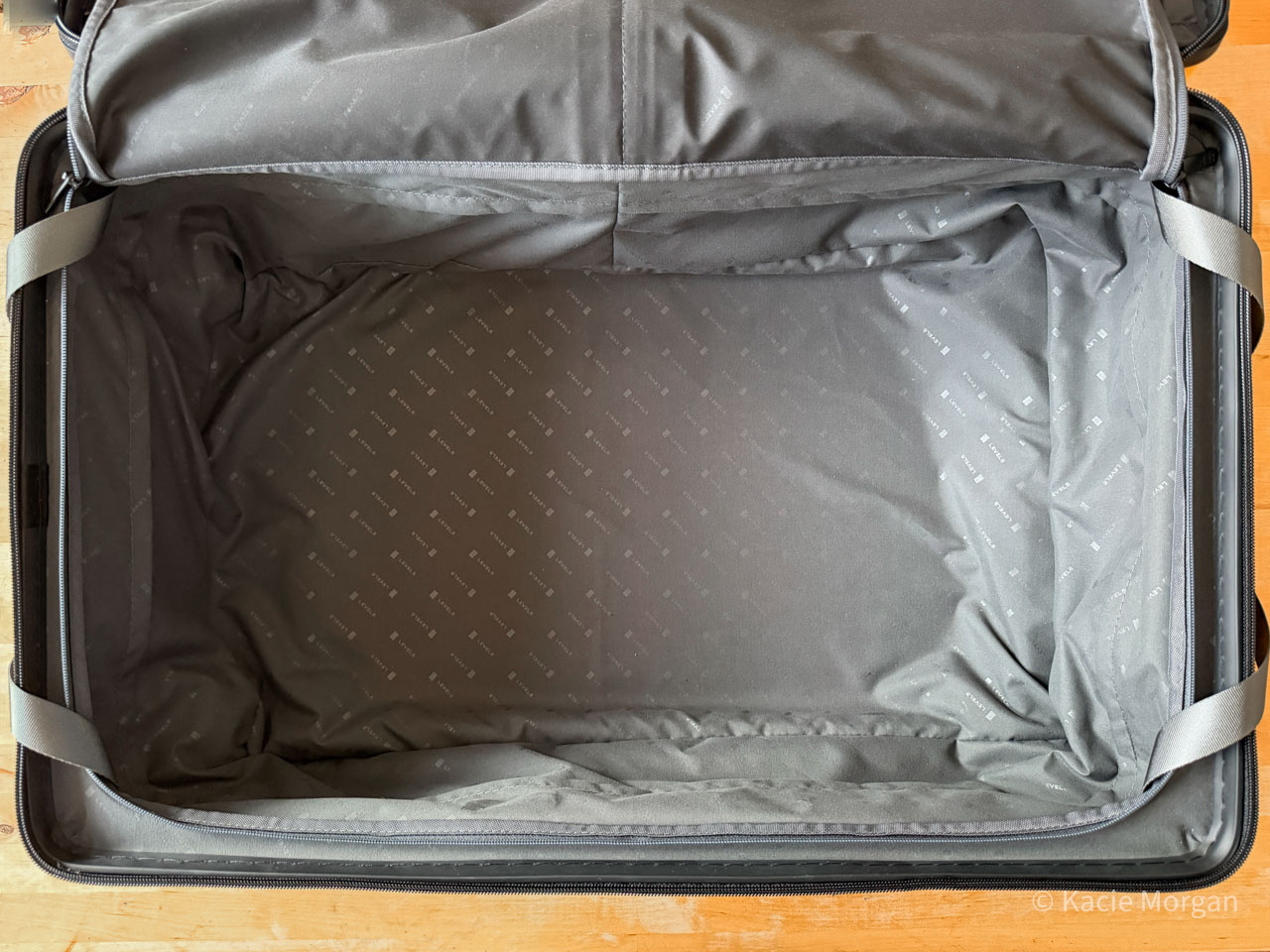 The interior of LEVEL8's Voyageur Checked case, completely flat thanks to the wide handle system.