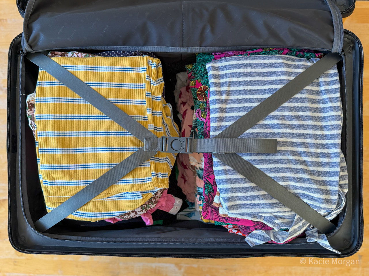 Clothes neatly folded inside LEVEL8's Voyageur Checked, making good use of the suitcase's compression system