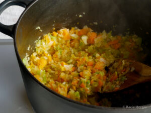 Softening the diced onion, celery and carrot in a casserole pan