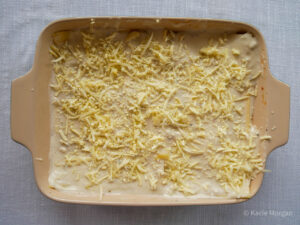 Scatter grated Caerphilly cheese over the Bechamel sauce