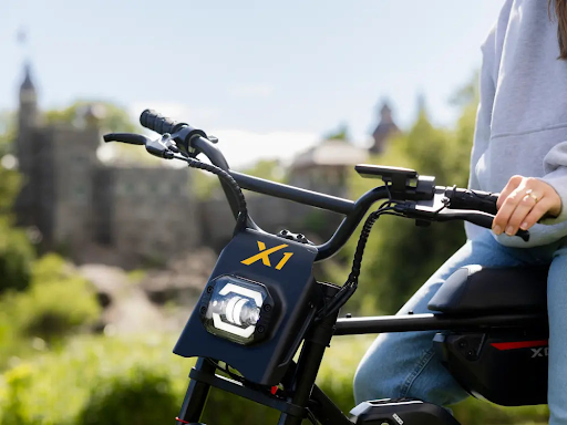 Someone holding the handles of an electric bike